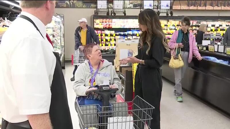 Gov. Kristi Noem talks with a shopper at a grocery store during her campaign last year.