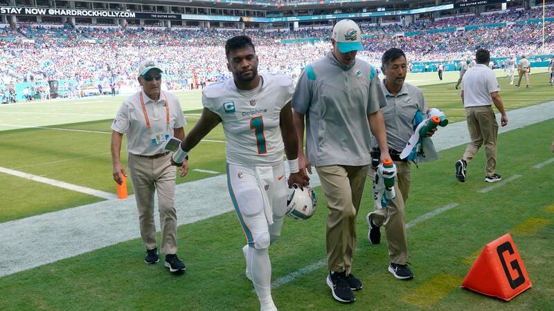 Miami Dolphins quarterback Tua Tagovailoa (1) is assisted off the field after he was injured...