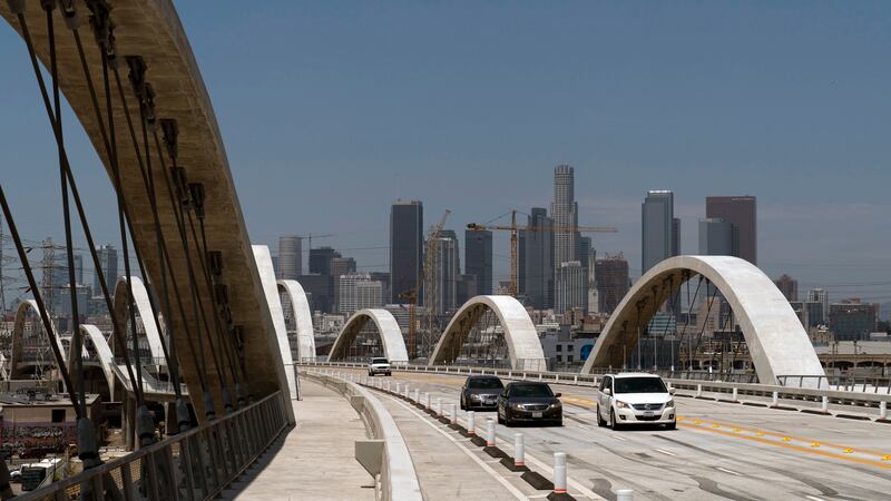 FILE - Cars move along the 6th Street Viaduct in Los Angeles, Wednesday, July 27, 2022. Police...