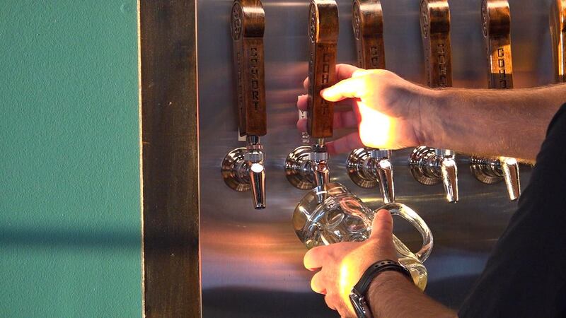 Jason Kingsbury pouring a beer at Cohort Craft Brewery.