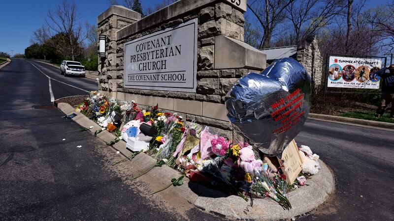 FILE - A balloon with names of the victims is seen at a memorial at the entrance to The...