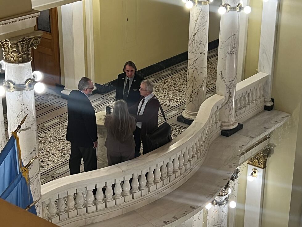 Senator Lee Schoenbeck (R-Watertown) consults with members of the Senate Democrat caucus,...