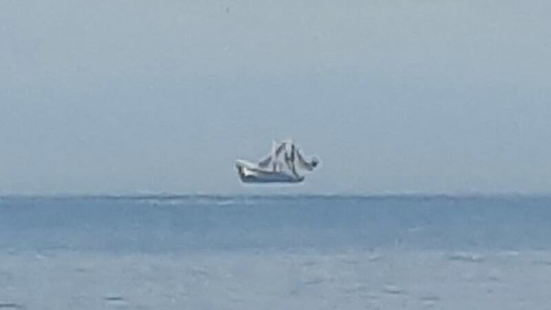 Oak Island beach goers had the chance to see a “hovering” ship on the water.